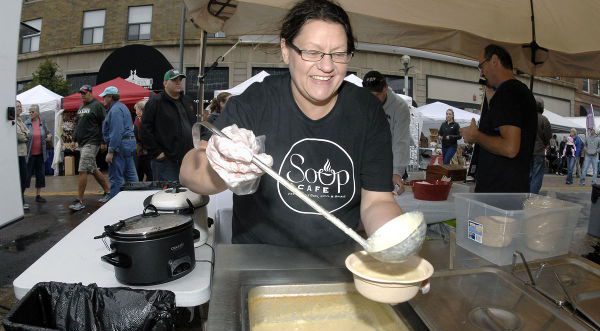 Volunteer serving soup.